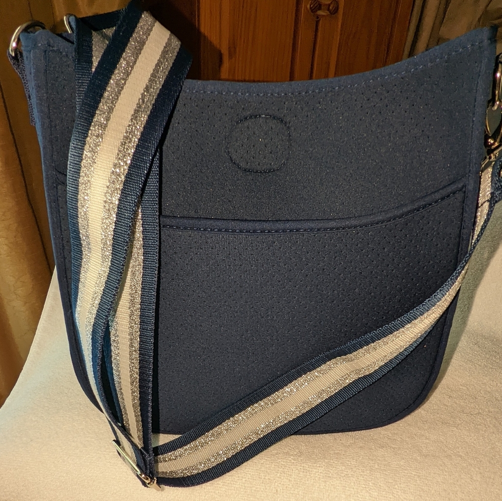Neoprene lightweight perforated crossbody bag.